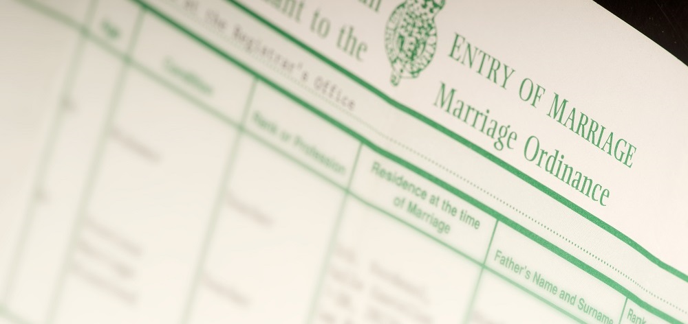 British marriage certificate showing headings with details blurred out.