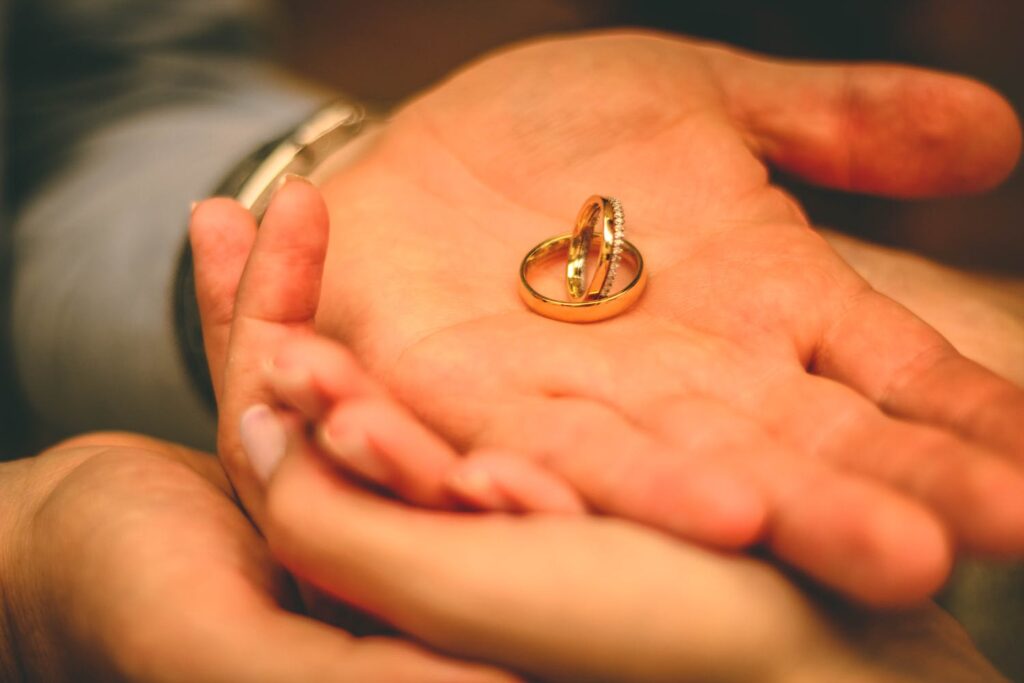 Man and Woman Holding Wedding Rings