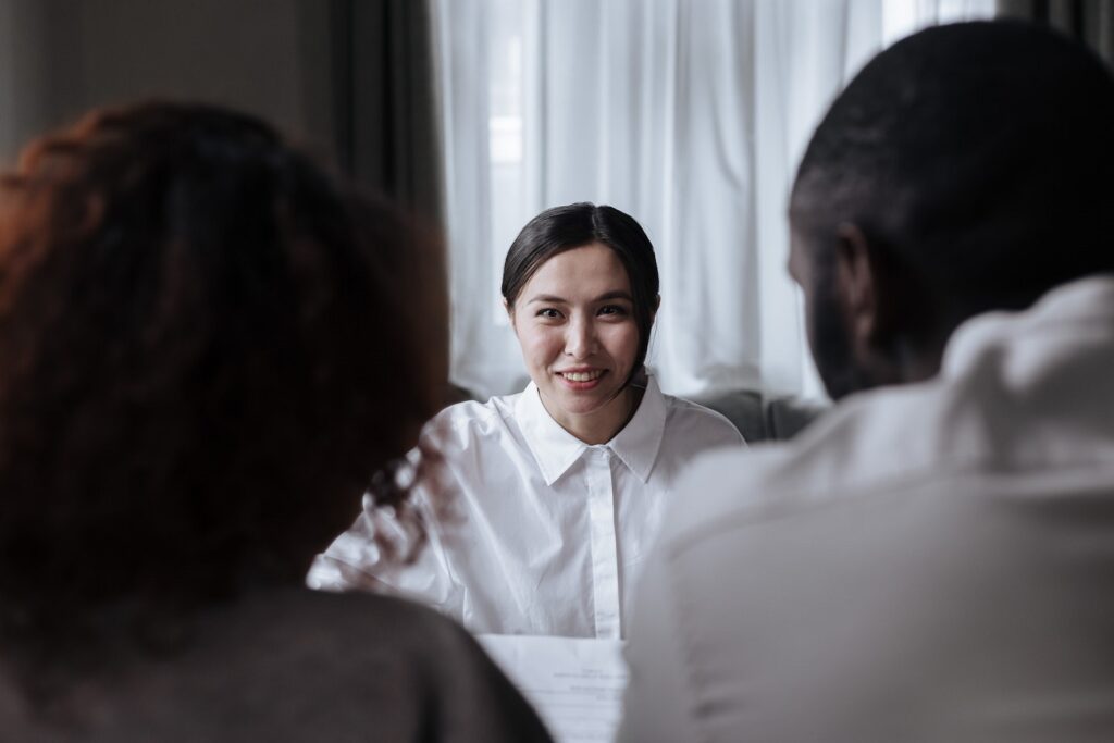 Couple Talking With Adoption Agency Employee