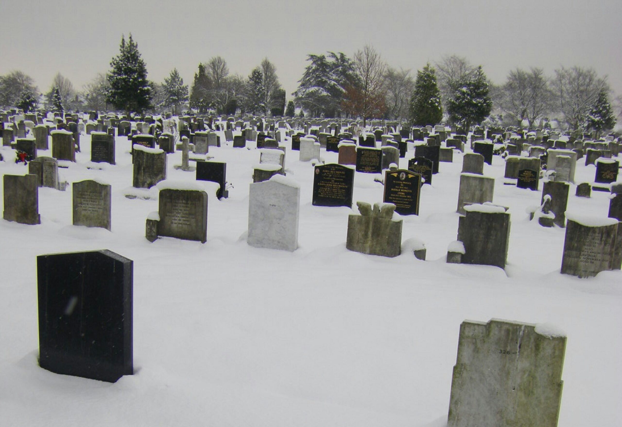 Snowy graveyard at Merton, UK